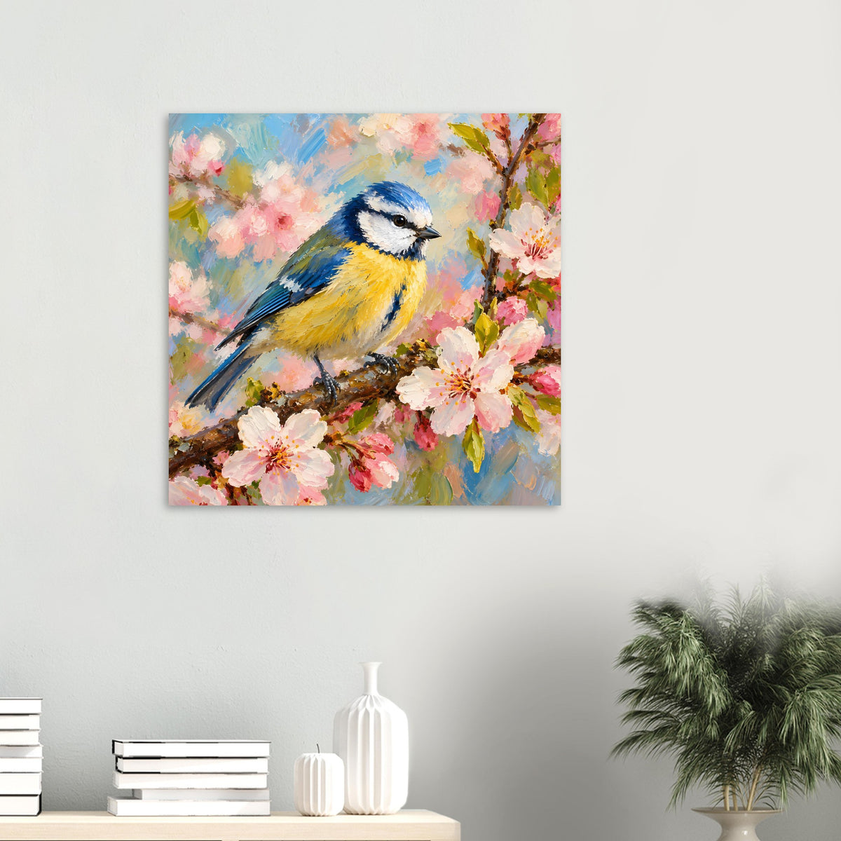 Kleines Vogelpocster im Querformat: blauer und gelber Vogel auf Ast mit rosa Blüten