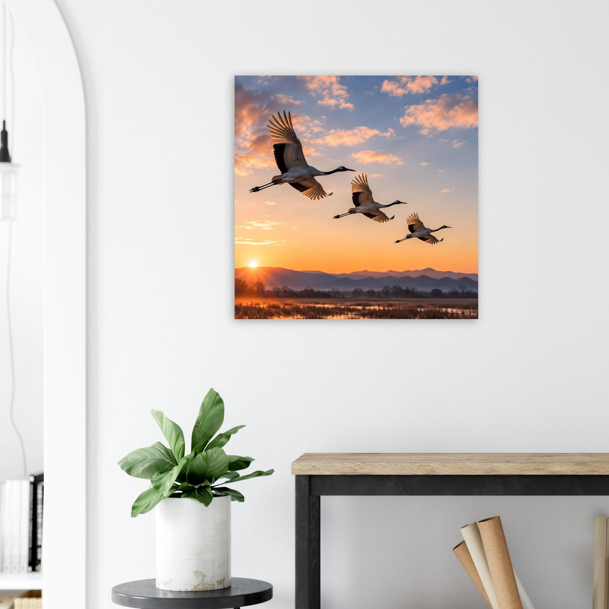 Wandposter mit Kranichen im Flug vor Sonnenuntergang über der Landschaft