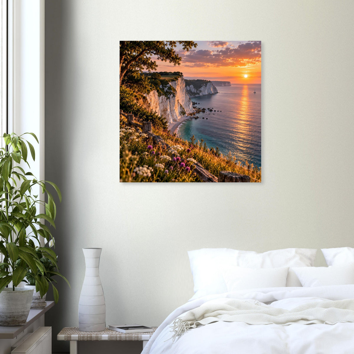 Quadratisches Wandposter mit Steilküste, blühendem Hang und Sonnenuntergang am Meer.