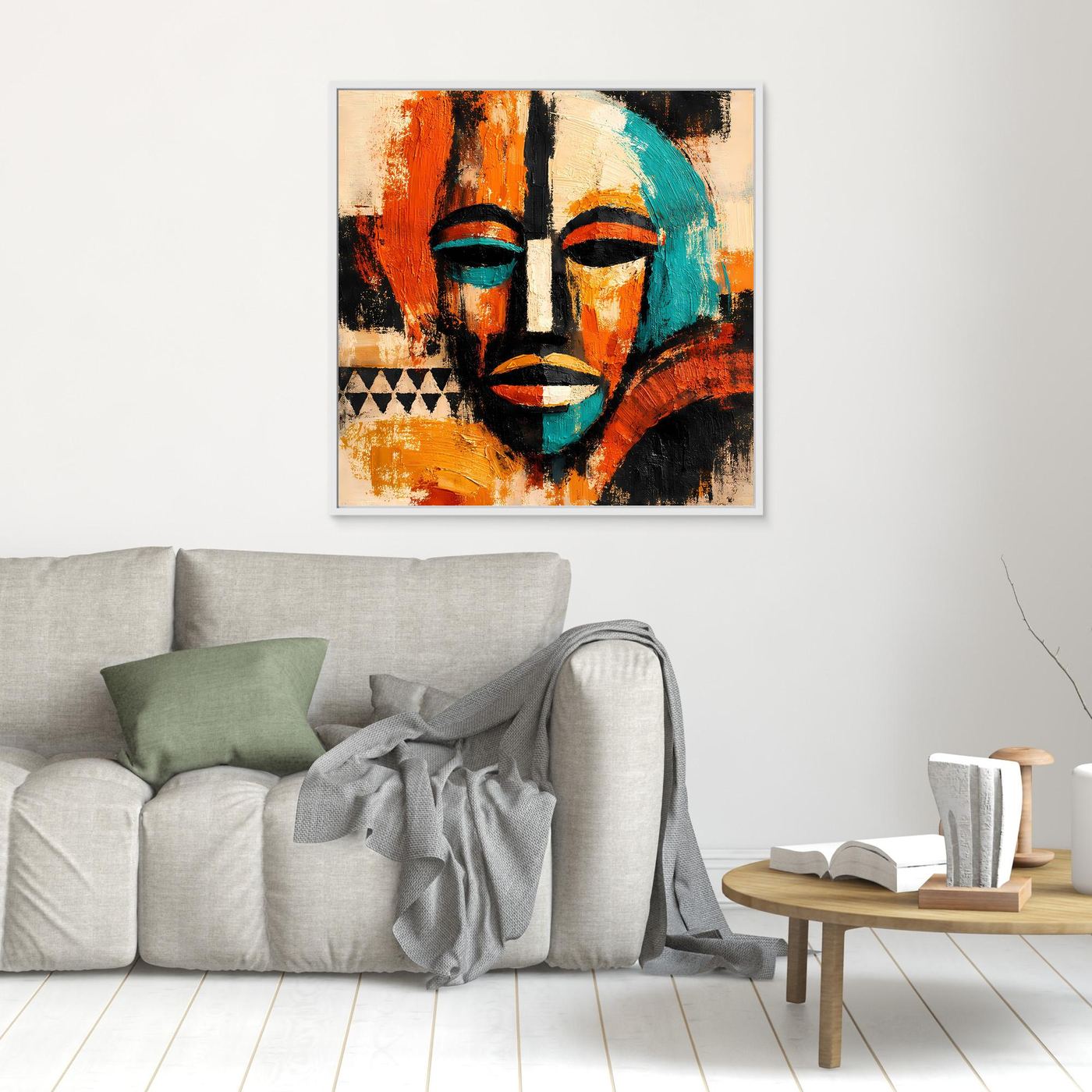 Small framed abstract mask portrait wall art, teal and orange faces with black accents.