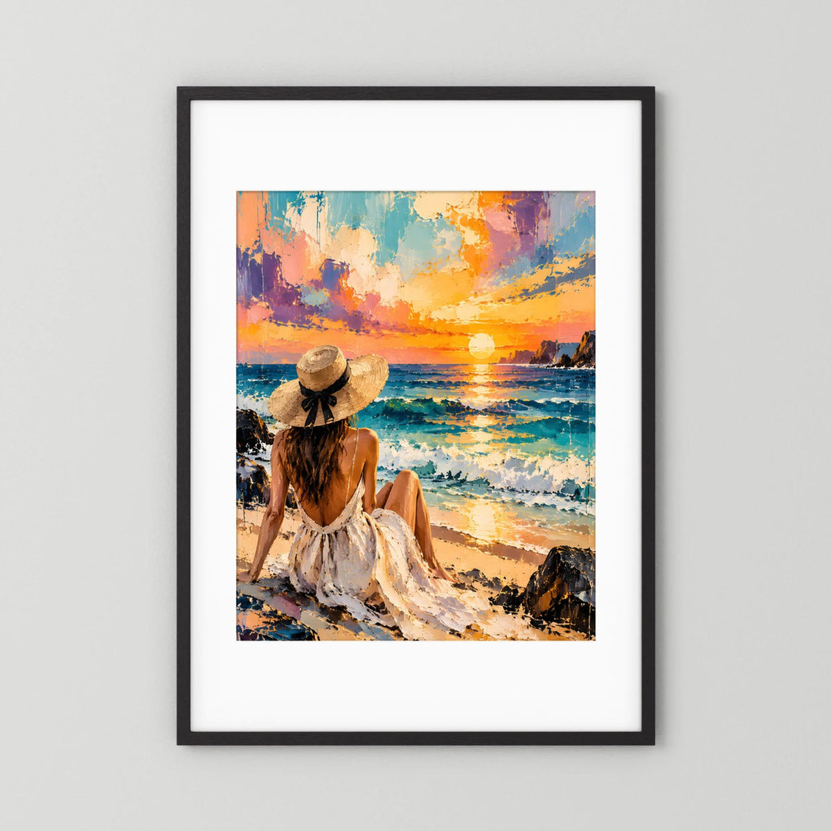 Poster im schwarzen Rahmen mit weißem Rand: sitzende Frau am Strand und orange-türkise Abendstimmung