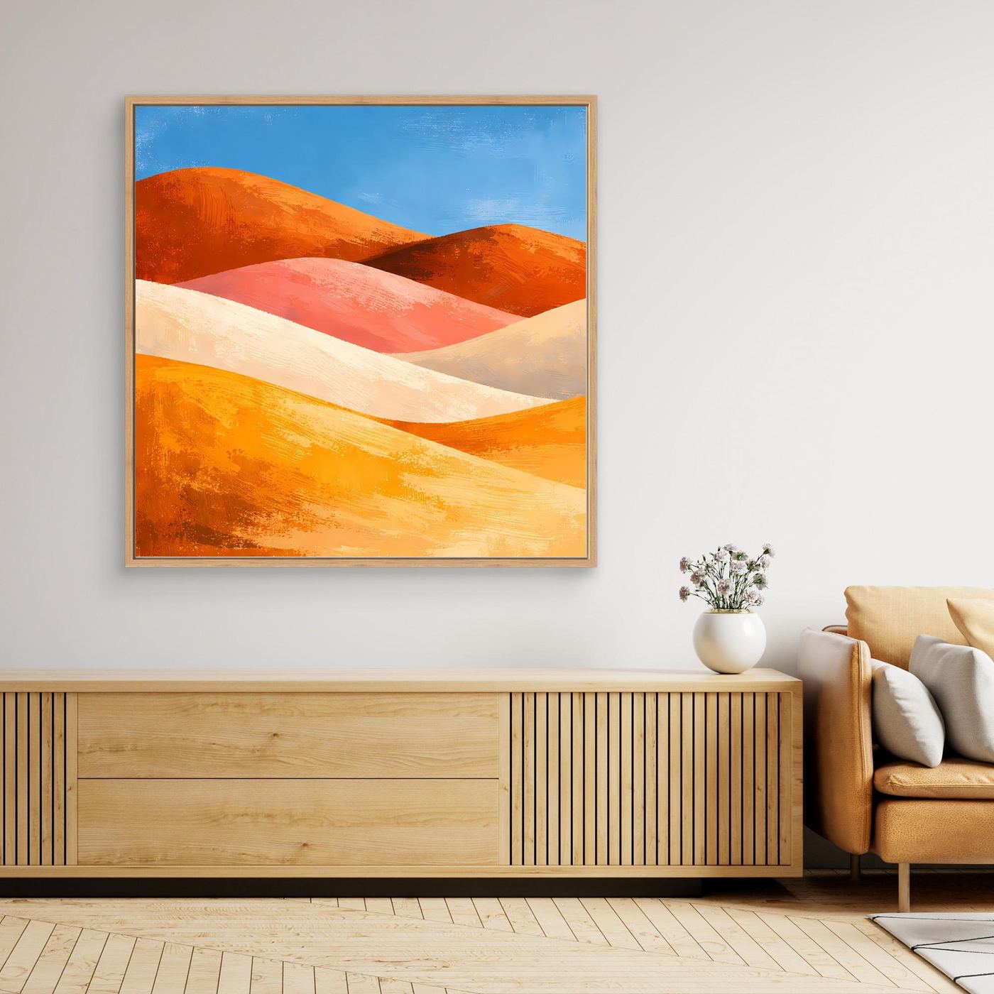 Gerahmtes Leinwandbild: bunte Dünen in Orange‑Rot‑Beige auf Leinwand mit blauem Himmel.