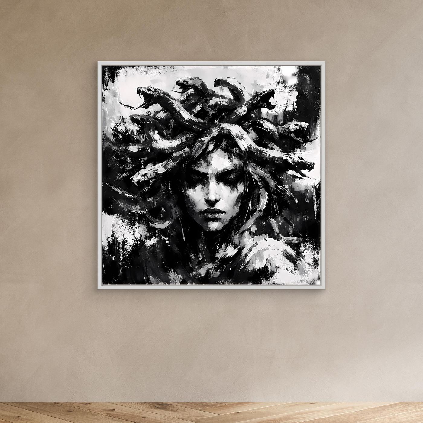 White-framed abstract Medusa portrait canvas in black and white, face and flowing hair visible.