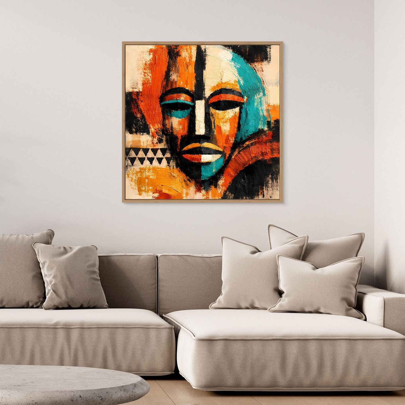 Framed abstract mask wall art with teal face, orange-red sections, and black lines