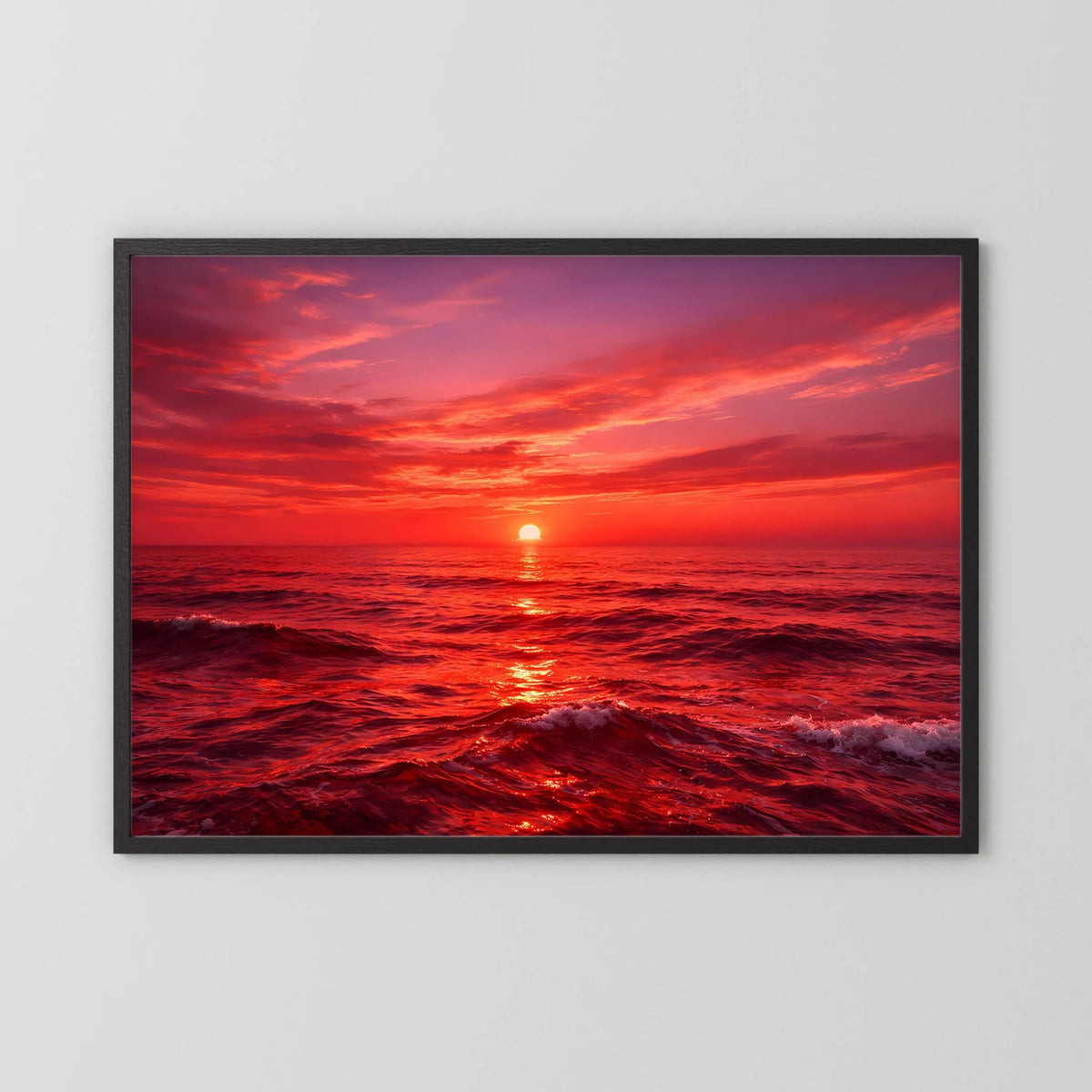 Querformatiges Wandbild mit Sonnenuntergang über dem Meer in schwarzem Rahmen