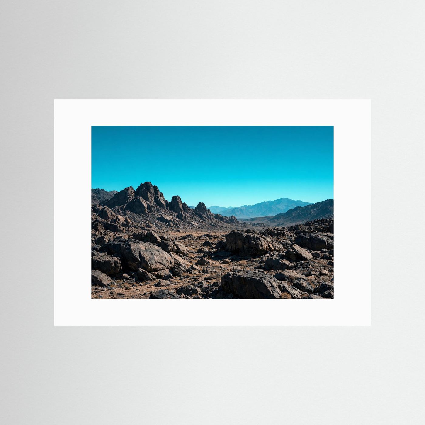 Poster mit Felsen- und Gebirgslandschaft in Wüste, mit weißem Passepartout