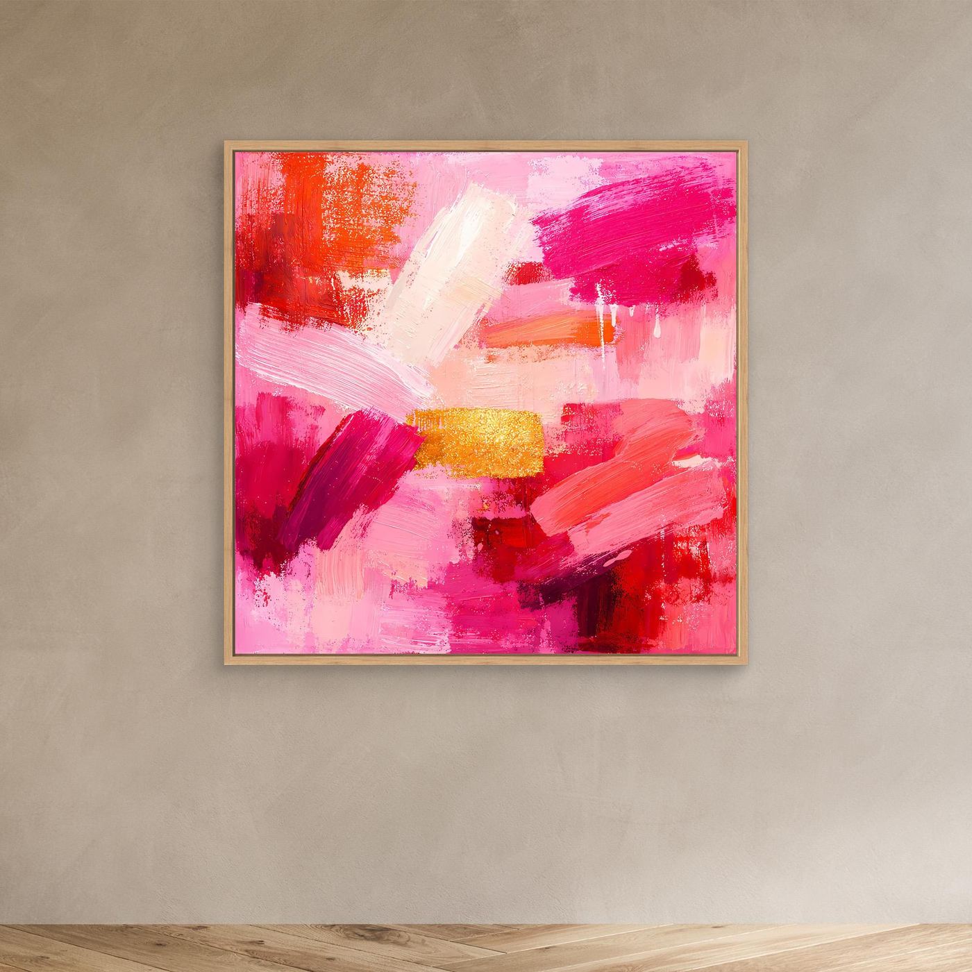 Abstract canvas wall art with pink and orange brushstrokes and gold accent, in a light frame.