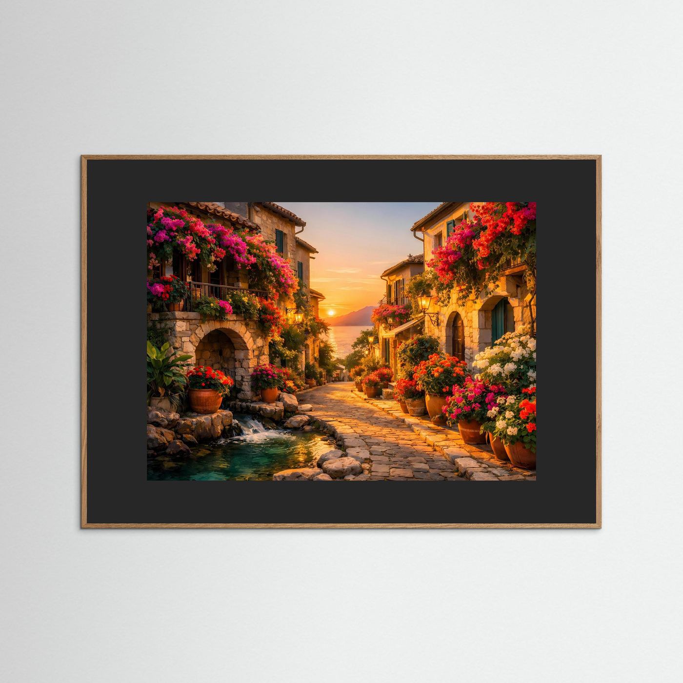 Gerahmtes Wandbild: mediterrane Gasse mit Blumen und Bach im Abendlicht, dunkler Rahmen.