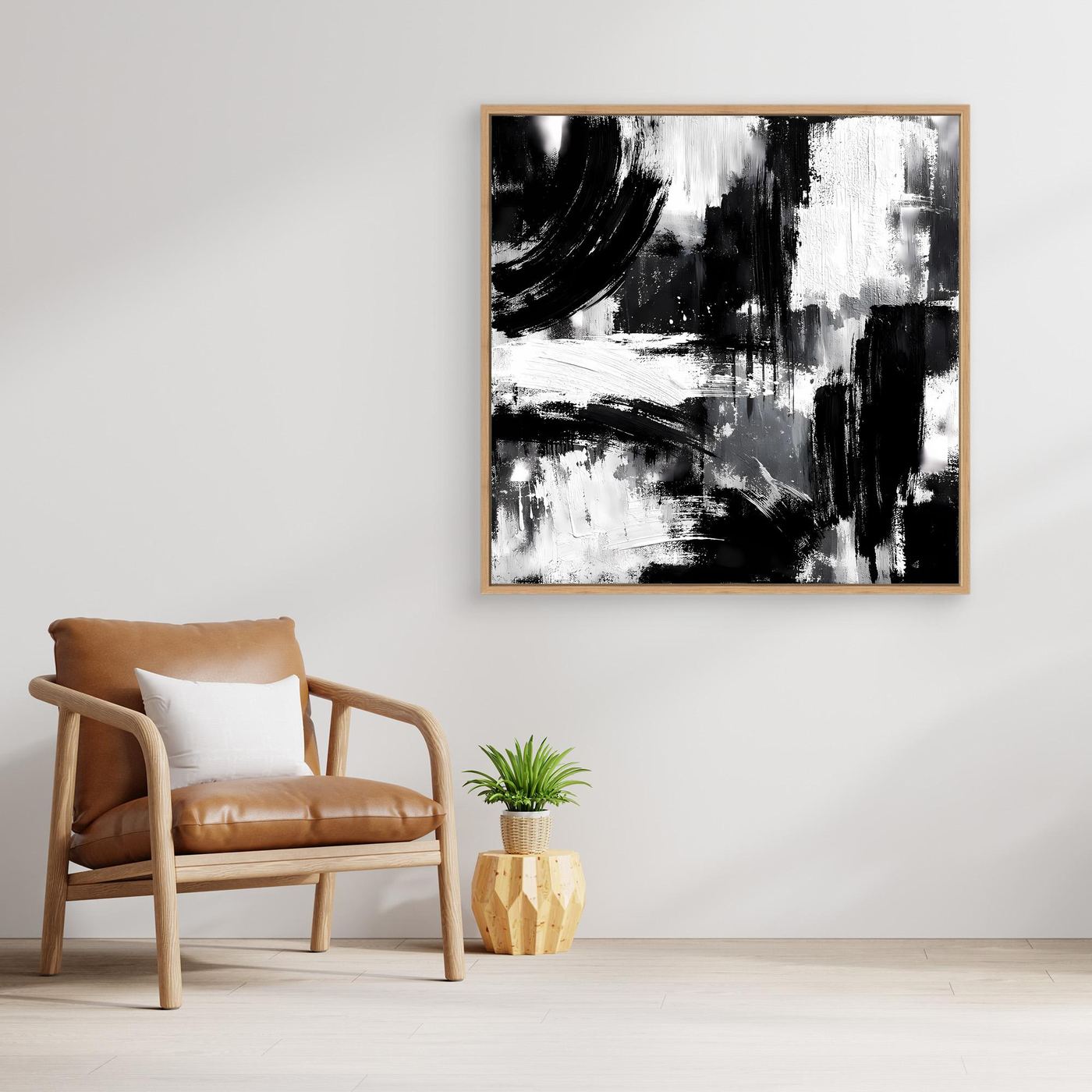 Square black-and-white abstract canvas painting in light wood frame