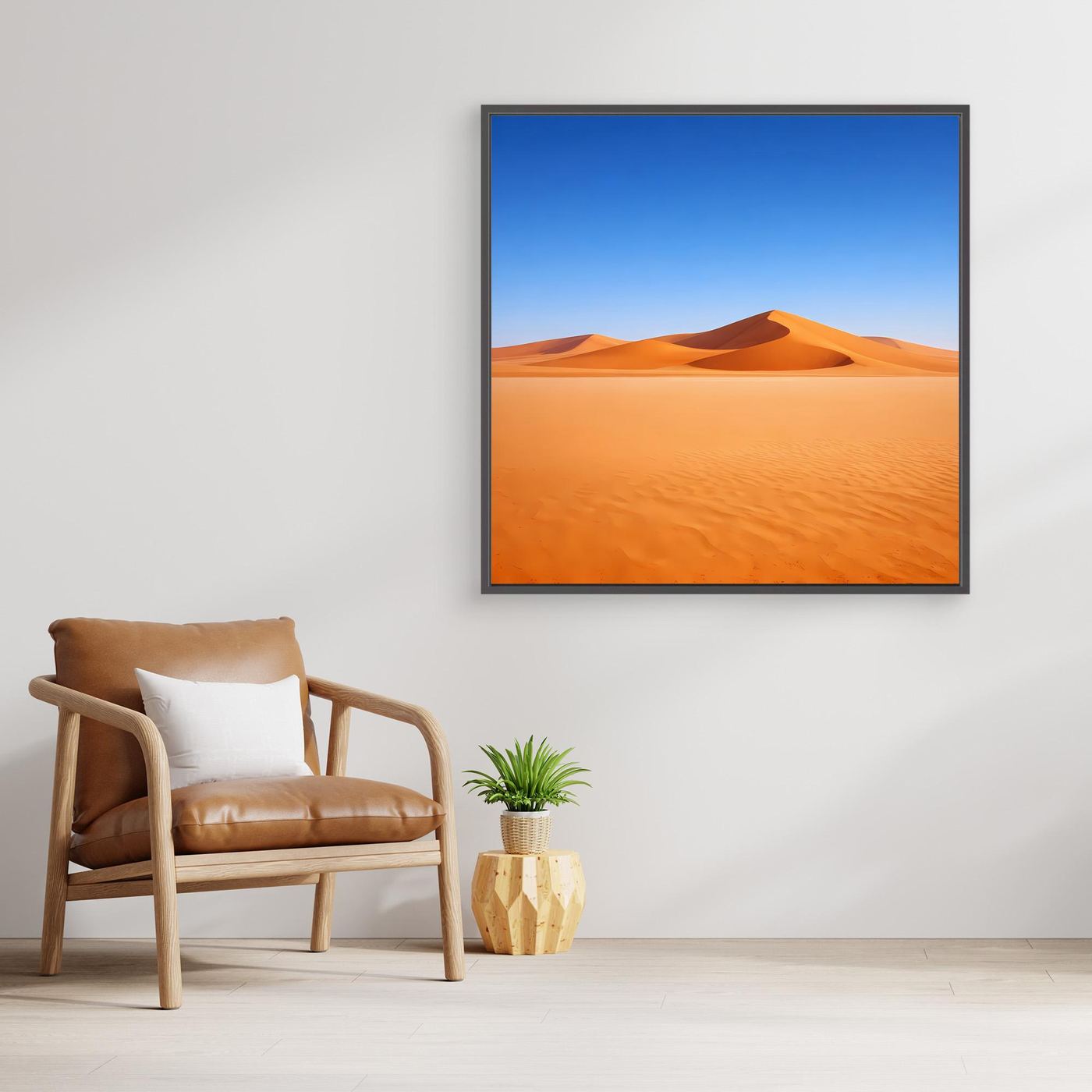 Leinwandbild mit Sanddünen im schwarzen Rahmen, blauem Himmel und orangefarbenen Wüstenflächen.