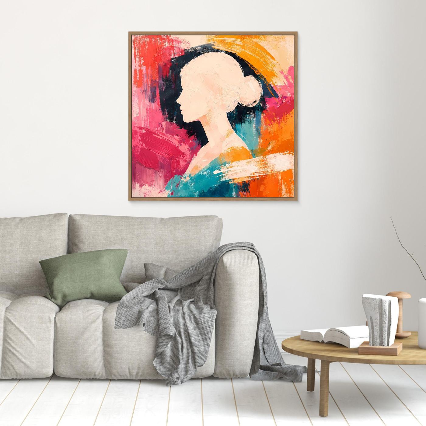 Oak-framed canvas wall art with a woman profile silhouette in pink, teal, and orange abstract paint.