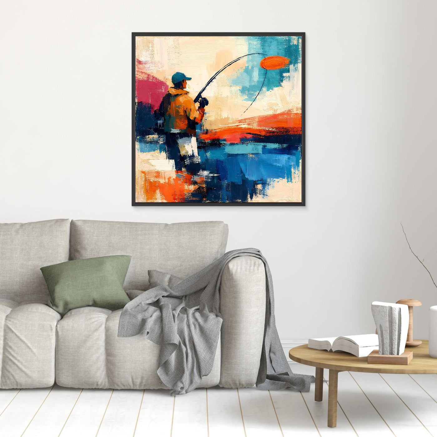 Abstract canvas wall art of an angler holding a fishing rod; orange, blue, and red; black frame.