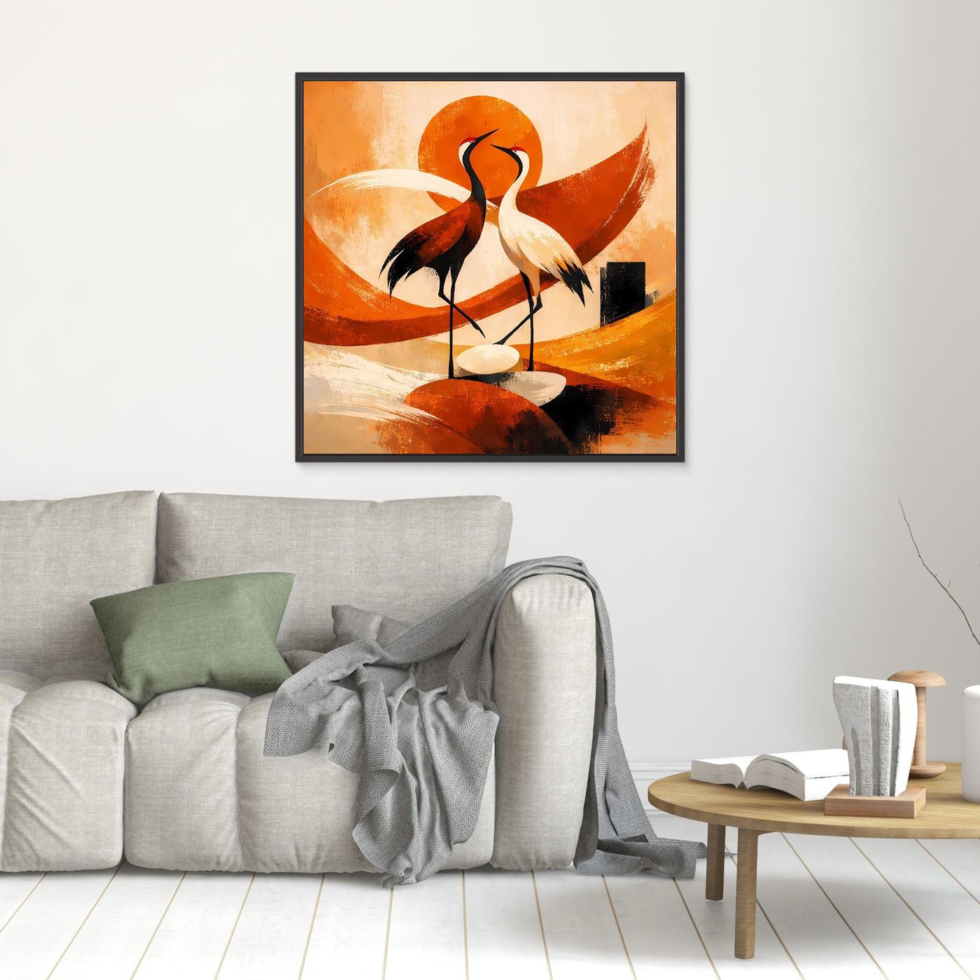 Wandbild mit zwei Kranichen im Sonnenmotiv, orangefarbene Formen, klein schwarz gerahmt.