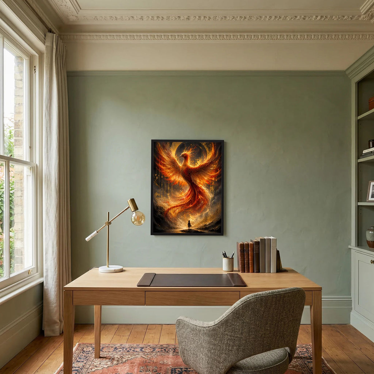 Hochformat-Poster mit Phönix aus Feuer in Gold und Orange, schwarzer Rahmen über Schreibtisch