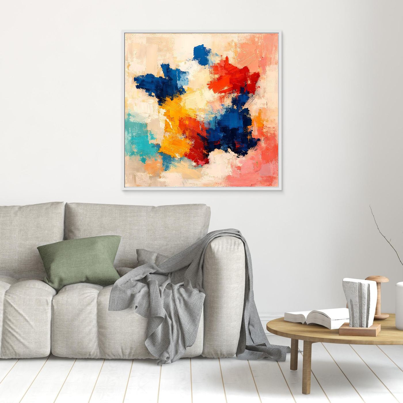 Abstract canvas wall art with blue, red, orange, yellow, and white paint in white frame