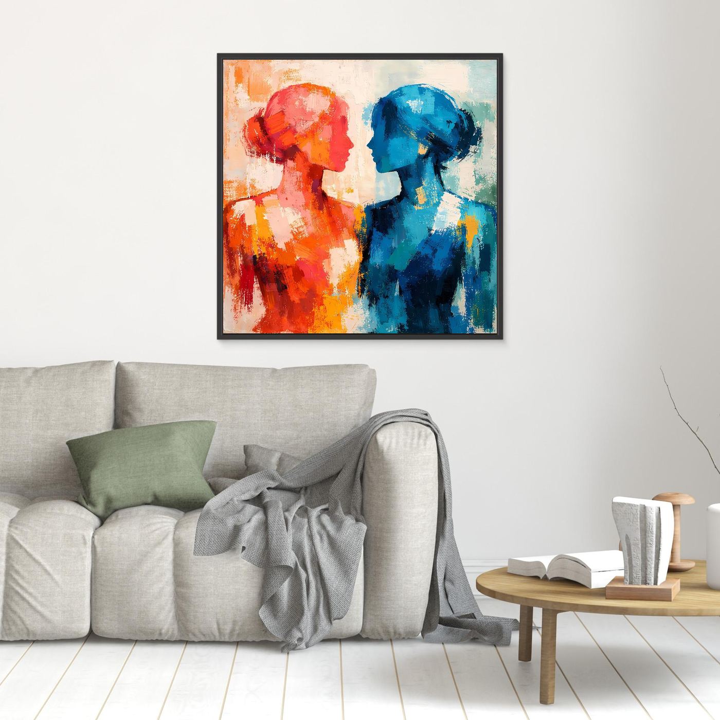 Kleines abstraktes Wandbild mit zwei Profilen, rot und blau, im schwarzen Rahmen