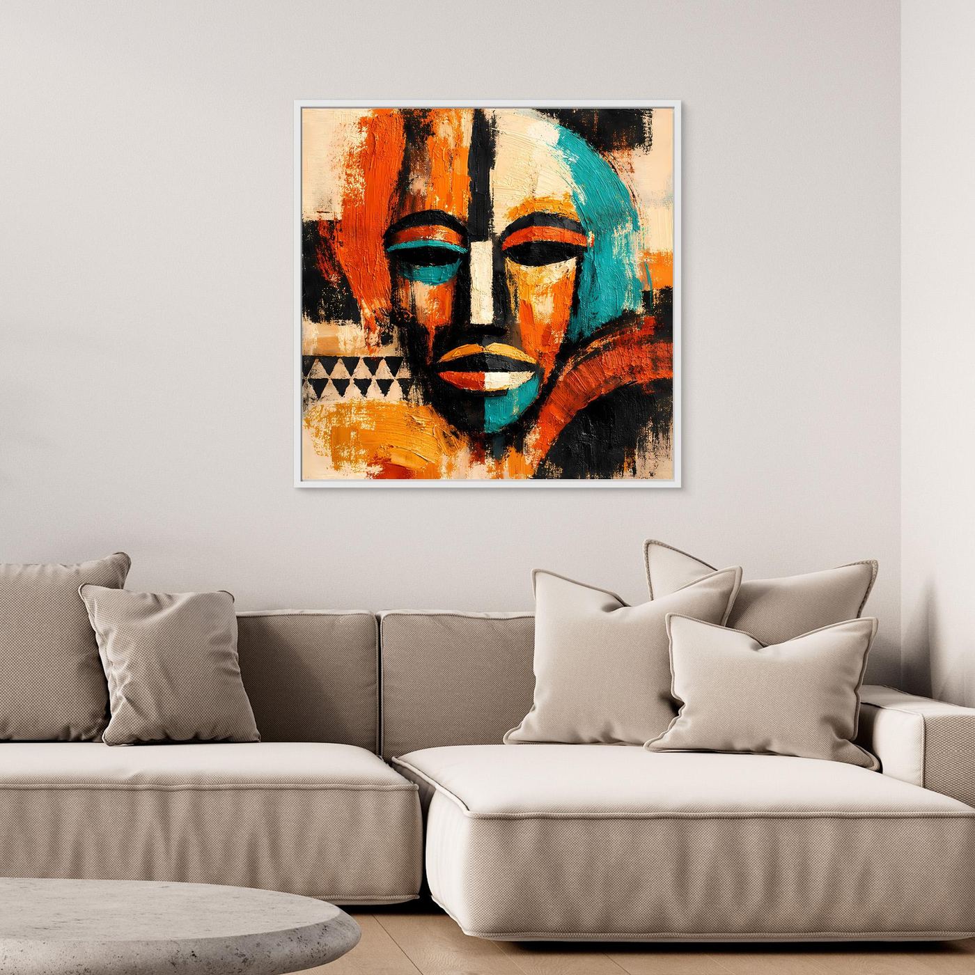 Framed abstract mask canvas with teal and black face details, orange-red and beige tones