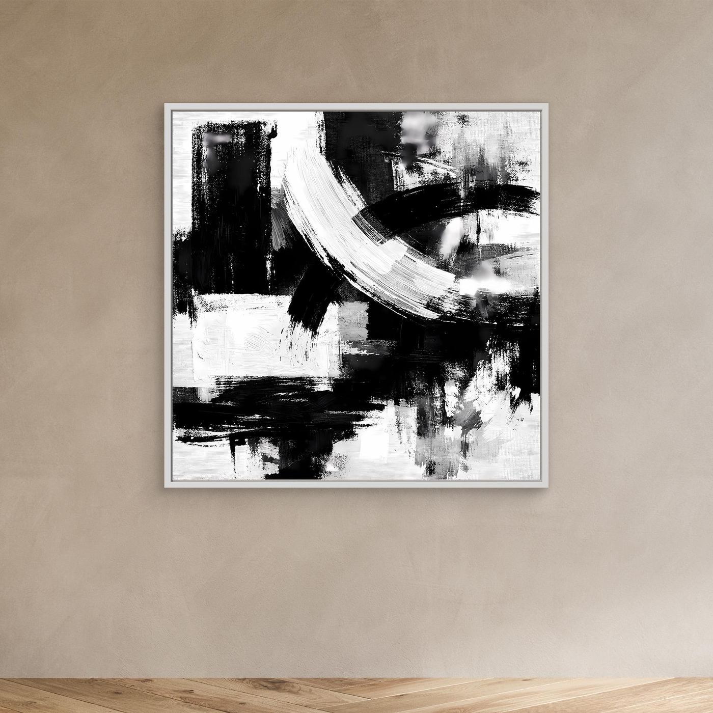 Black-and-white abstract brushstroke canvas wall art in white frame on wall, minimalist