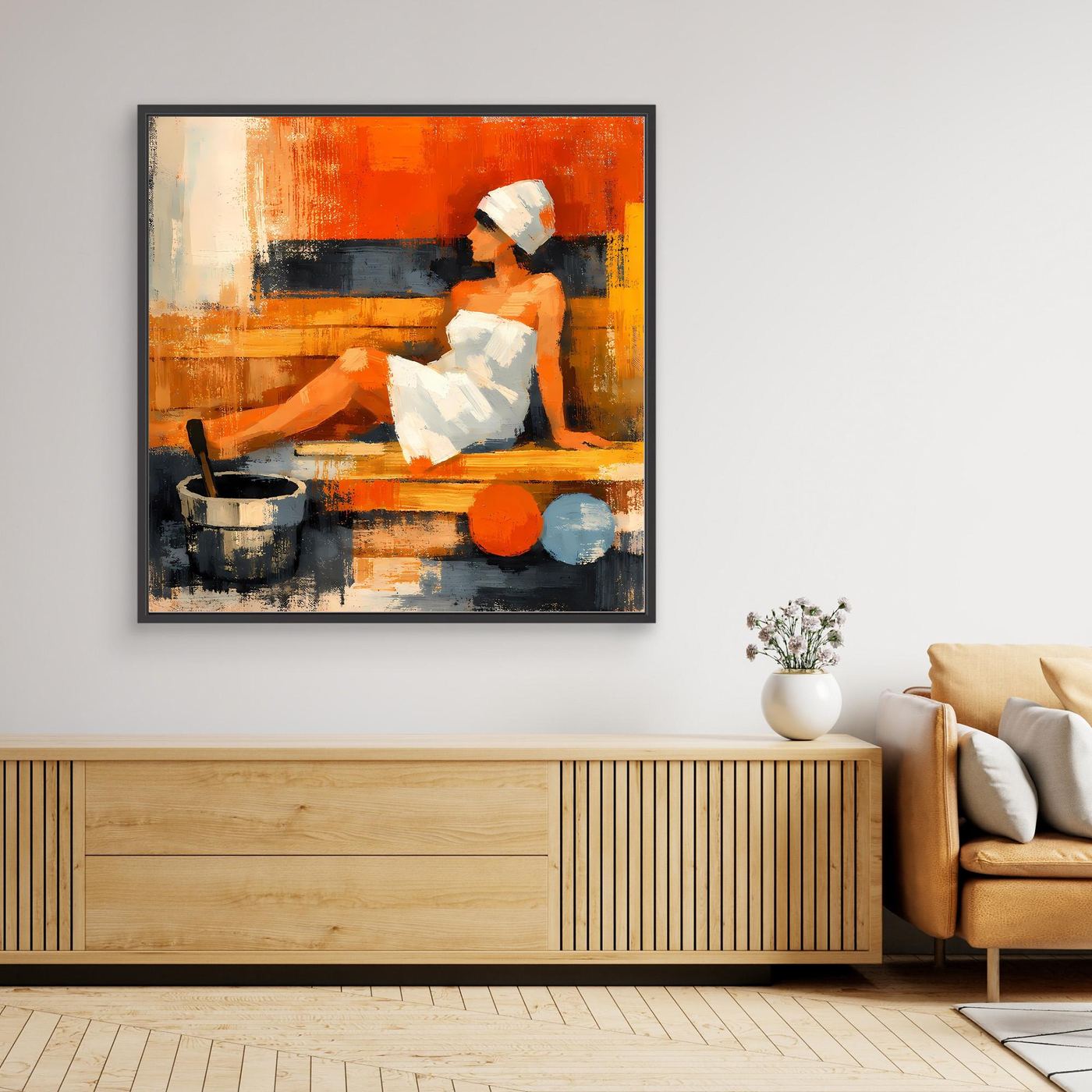 Black-framed abstract canvas wall art with seated woman in orange and dark tones