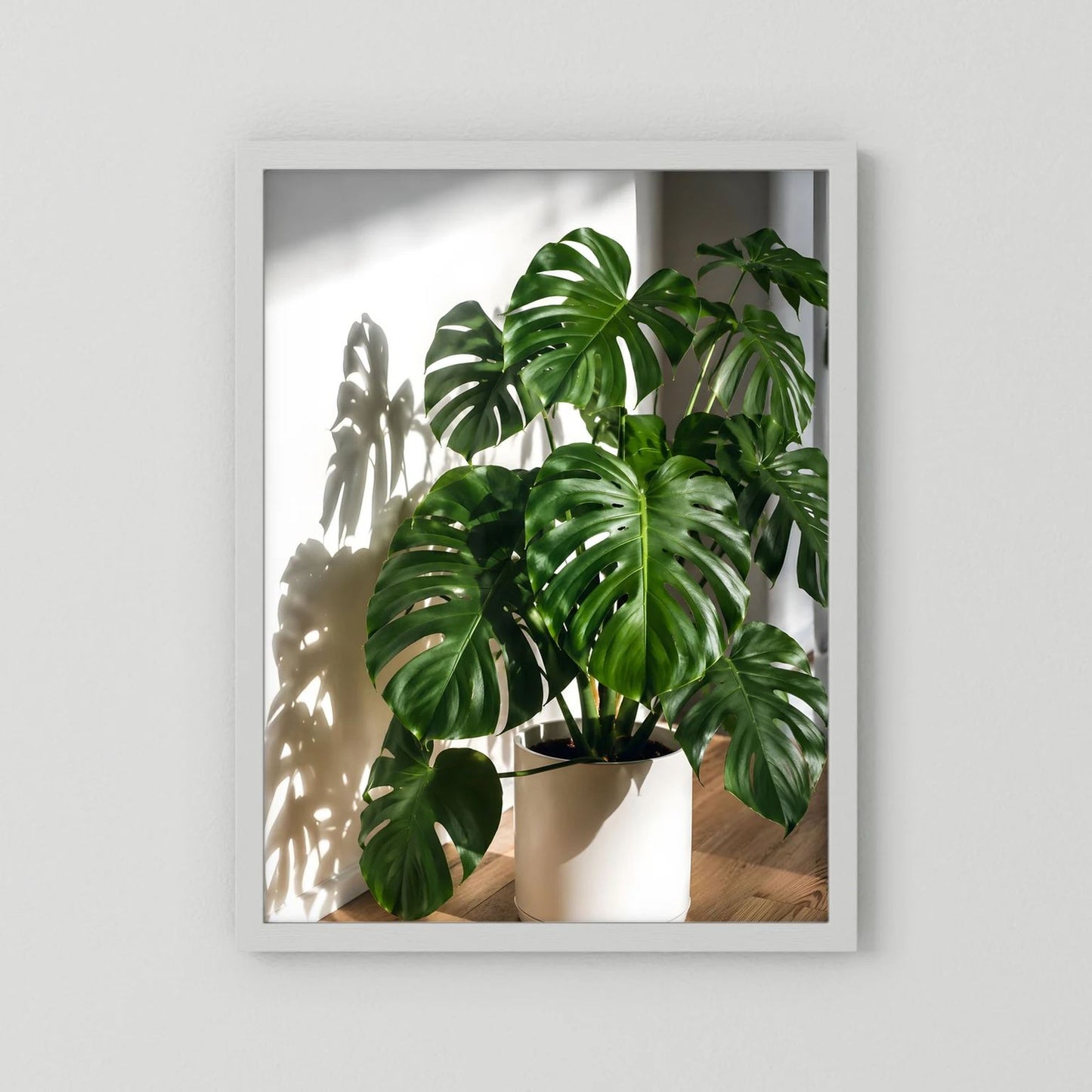 Monstera-Poster mit weißem Rahmen, grüne Blätter im weißen Pflanztopf
