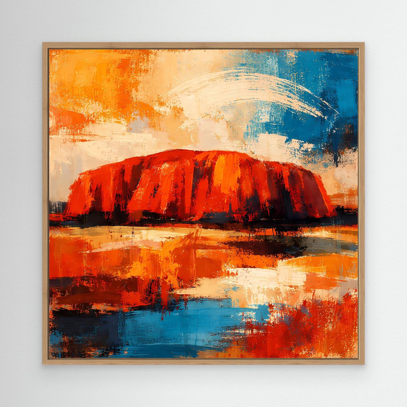 Leinwand-Wandbild Uluru-Fels mit Eichenrahmen in Rot/Orange und Blau.