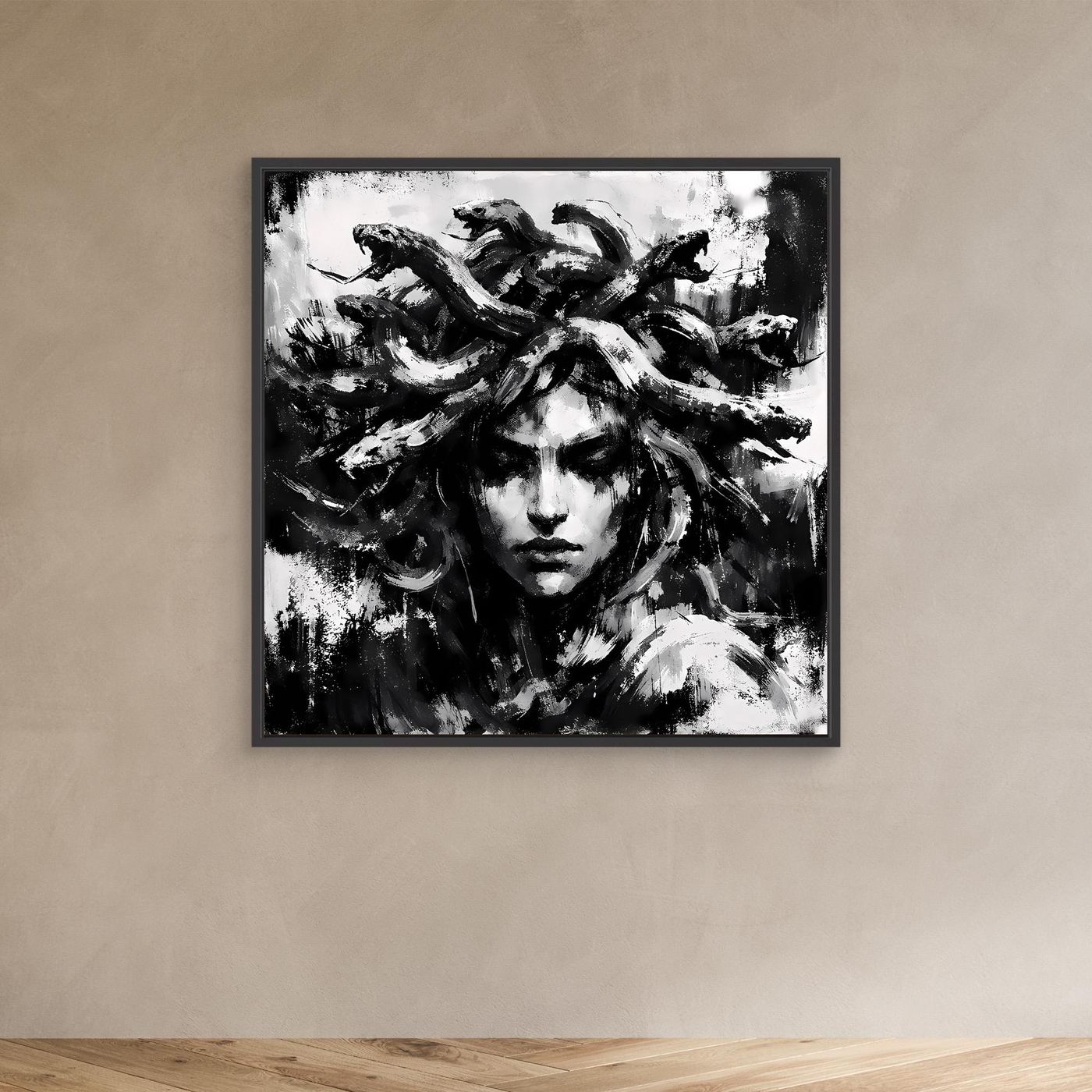 Black-framed abstract Medusa portrait canvas in black and white, face and flowing hair visible.