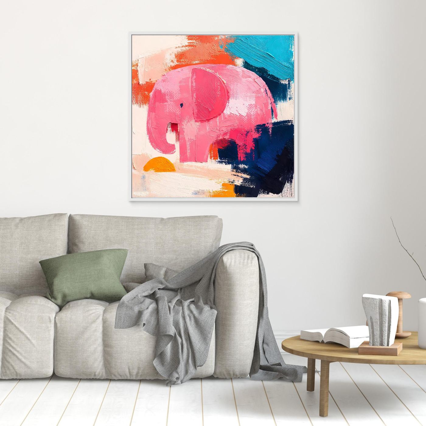 Small white-framed abstract elephant canvas with pink head and blue-orange brushwork