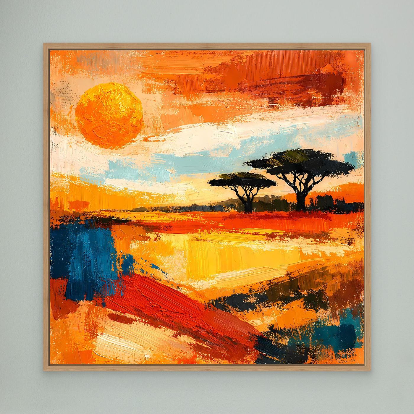 Framed abstract landscape canvas with orange sunset sky, sun disc, and acacia silhouettes in a light wood frame.