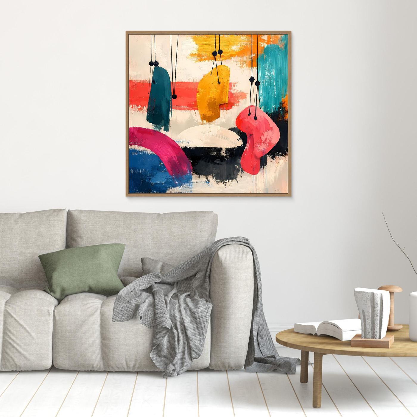 Gold-framed abstract wall art with hanging organic shapes in teal, yellow, pink, blue