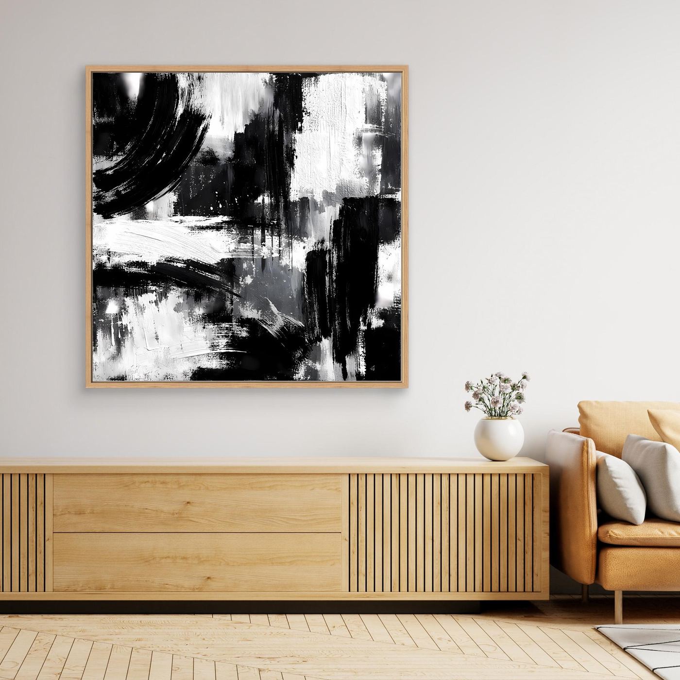 Square black-and-white abstract canvas painting in light wood frame