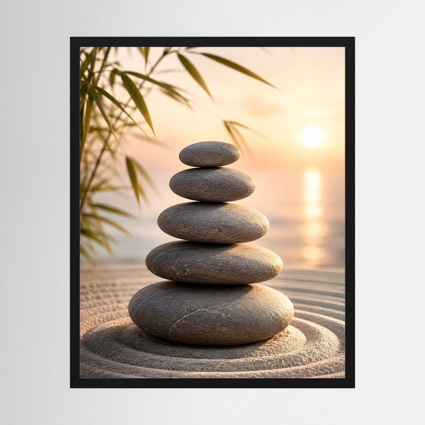 Kunstposter im Hochformat mit schwarzem Rahmen und Stapel dunkler Steine am Strand