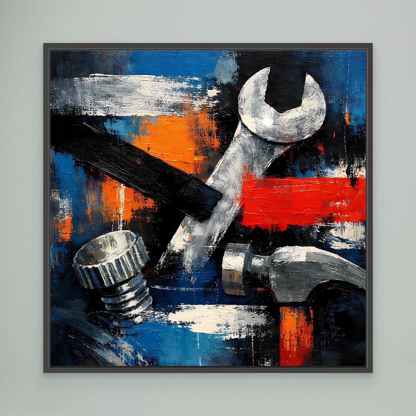 Framed abstract tool wall art with wrench and tools in blue, orange and red, dark frame.