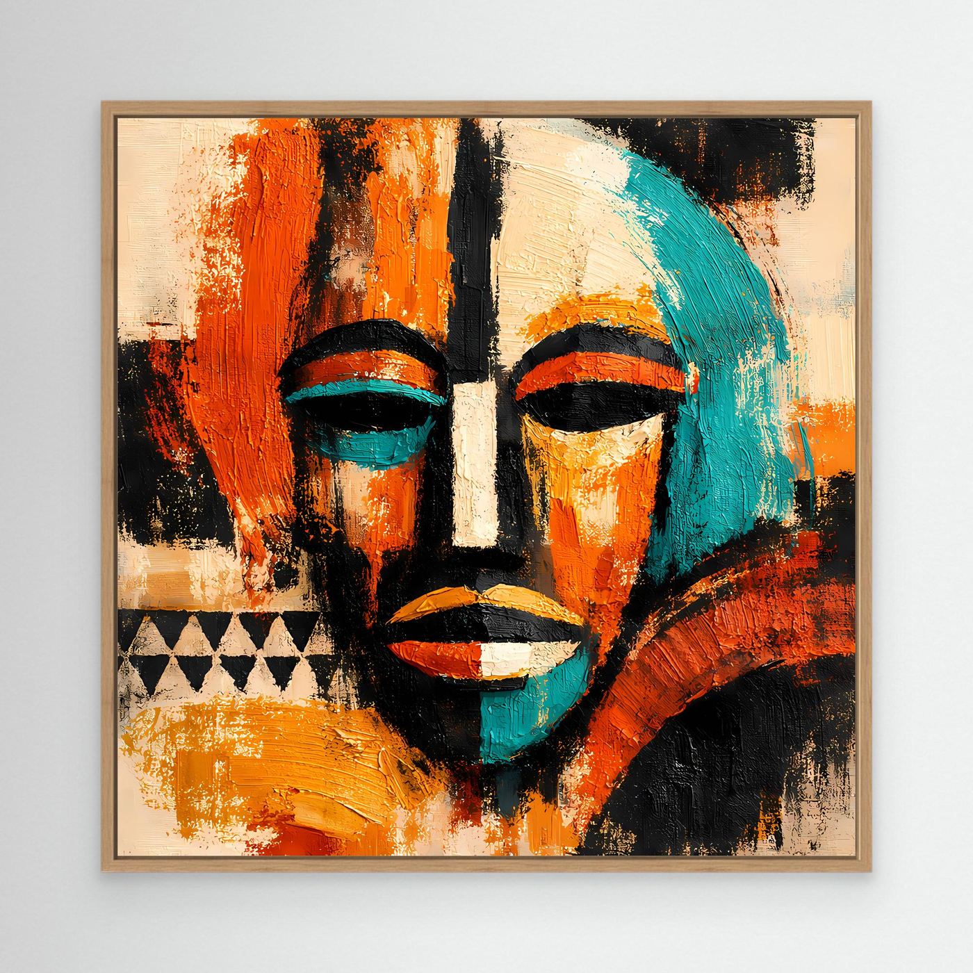 Abstract mask portrait canvas with teal and orange faces and black accents, oak frame