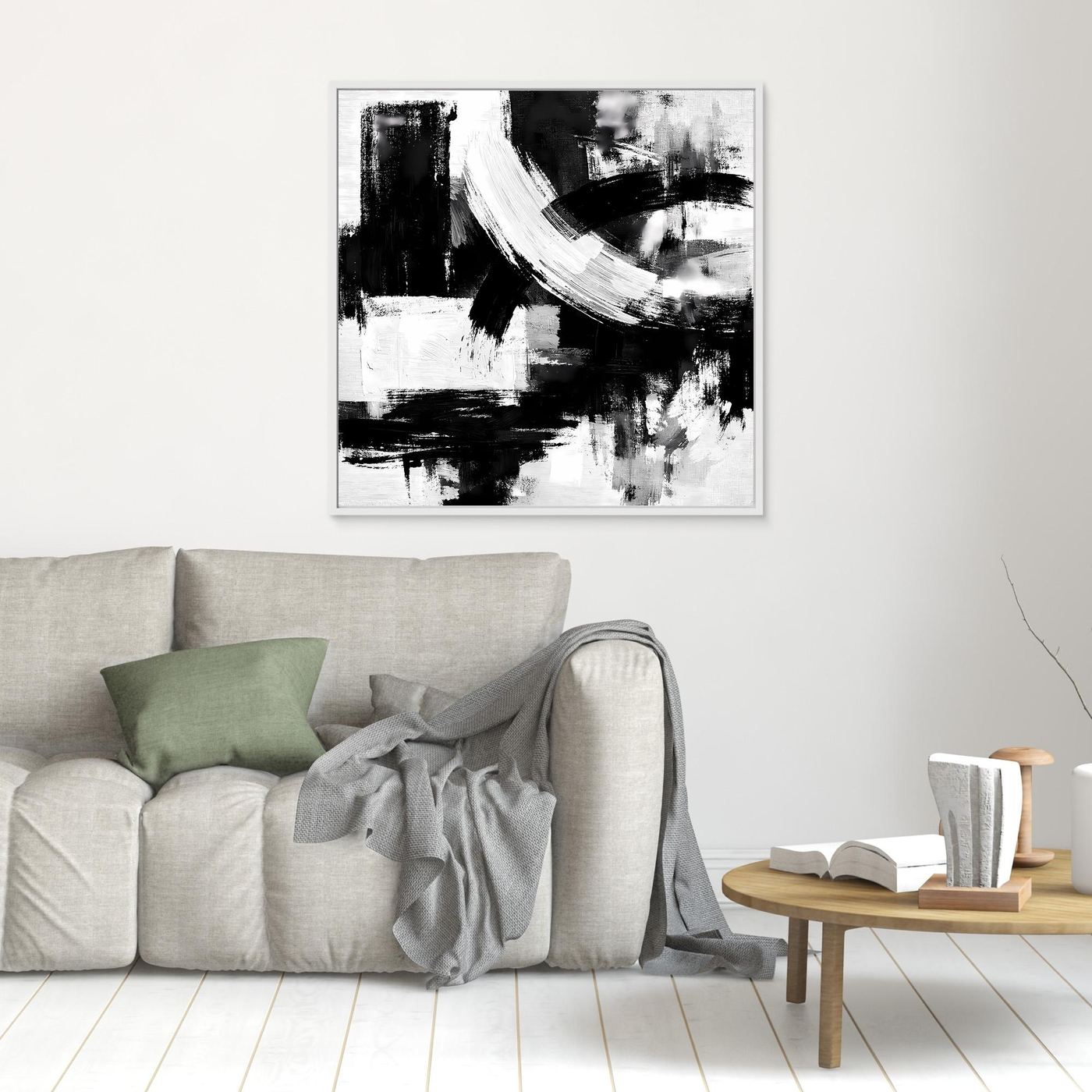 Abstract canvas wall art with black and white brush strokes, in a thin silver frame