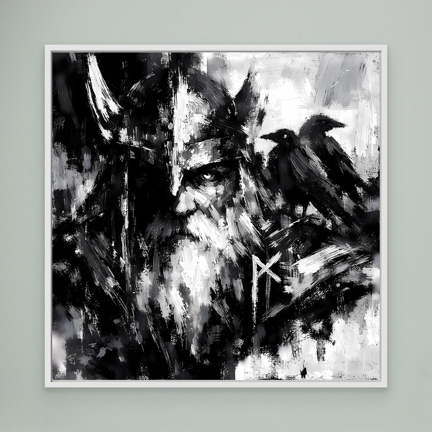 Leinwand-Wandbild mit Odin-Porträt, Rabe und Runensymbol in Schwarzweiß, weiß gerahmt.