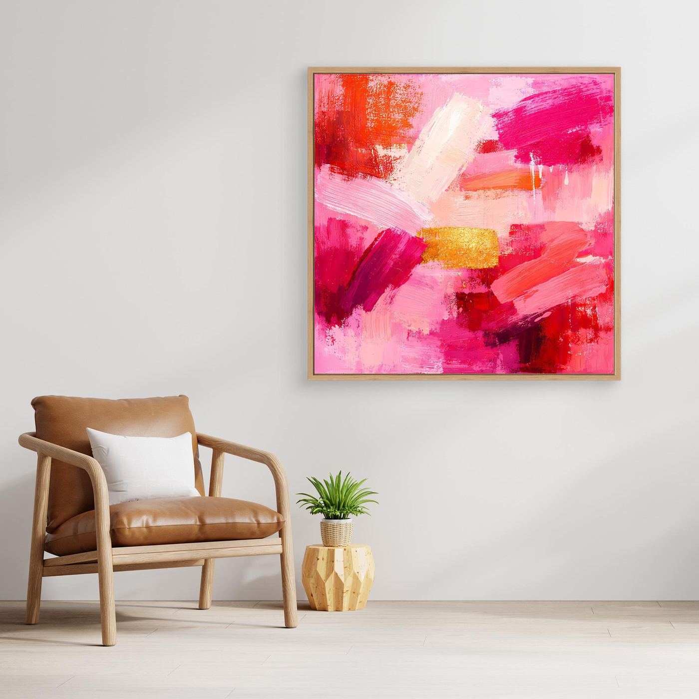 Abstract canvas wall art with pink and rose brushstrokes and small gold accents, gold frame.