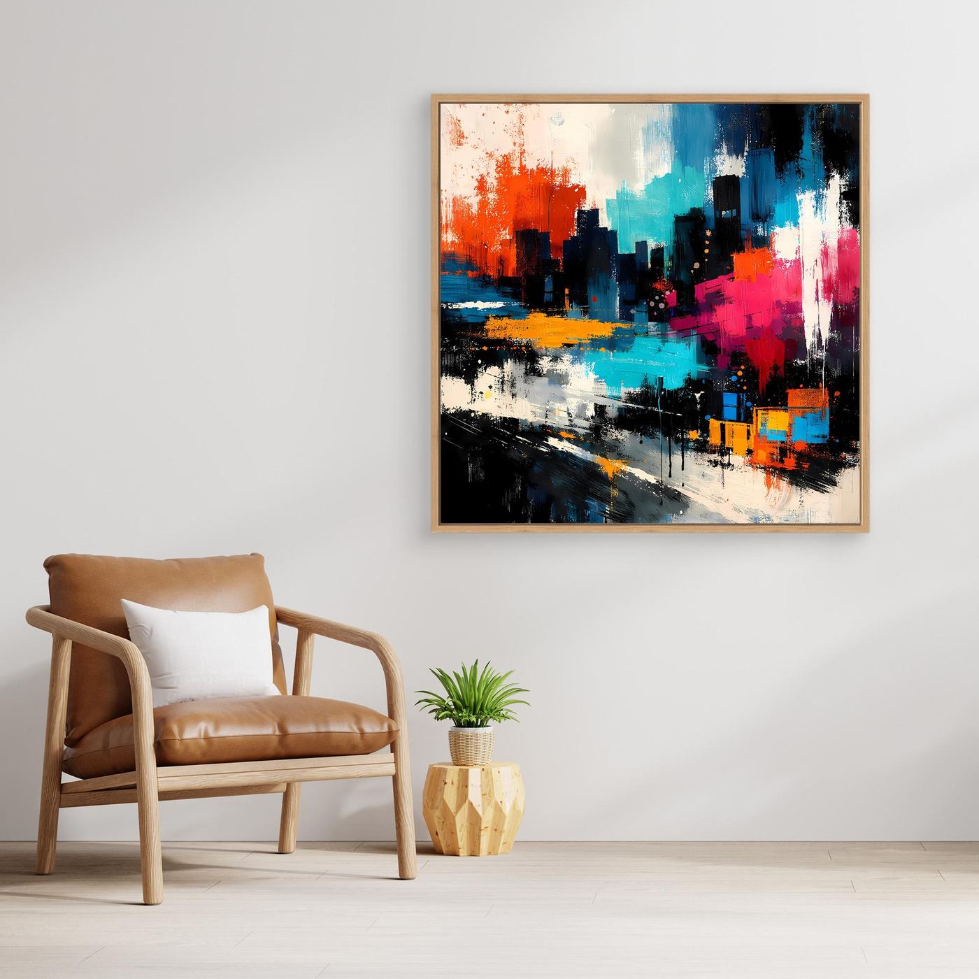Abstract city skyline wall art with red, teal, and dark blue paint, in a light wood frame