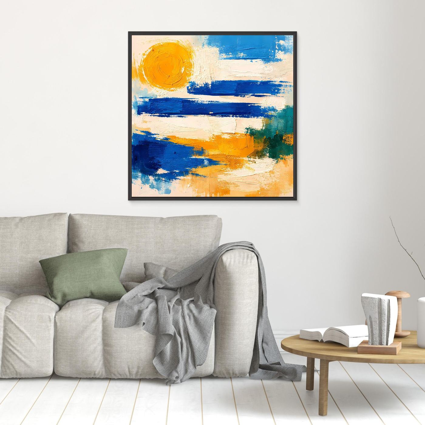 Black-framed abstract canvas wall art with blue waves and yellow sun brushstrokes.