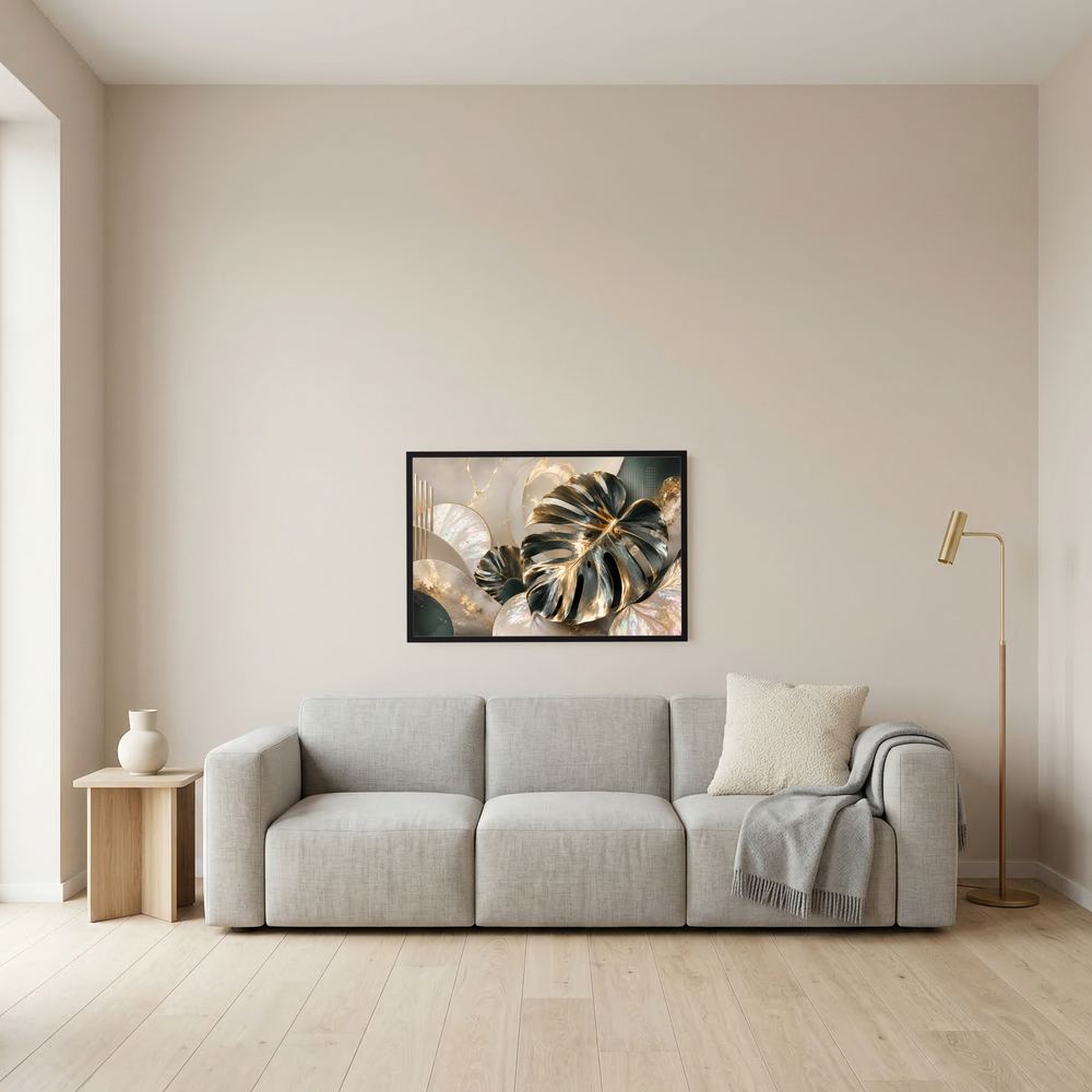 Wandposter mit goldenen Monstera-Blättern auf cremefarbenem Hintergrund, schwarzer Rahmen