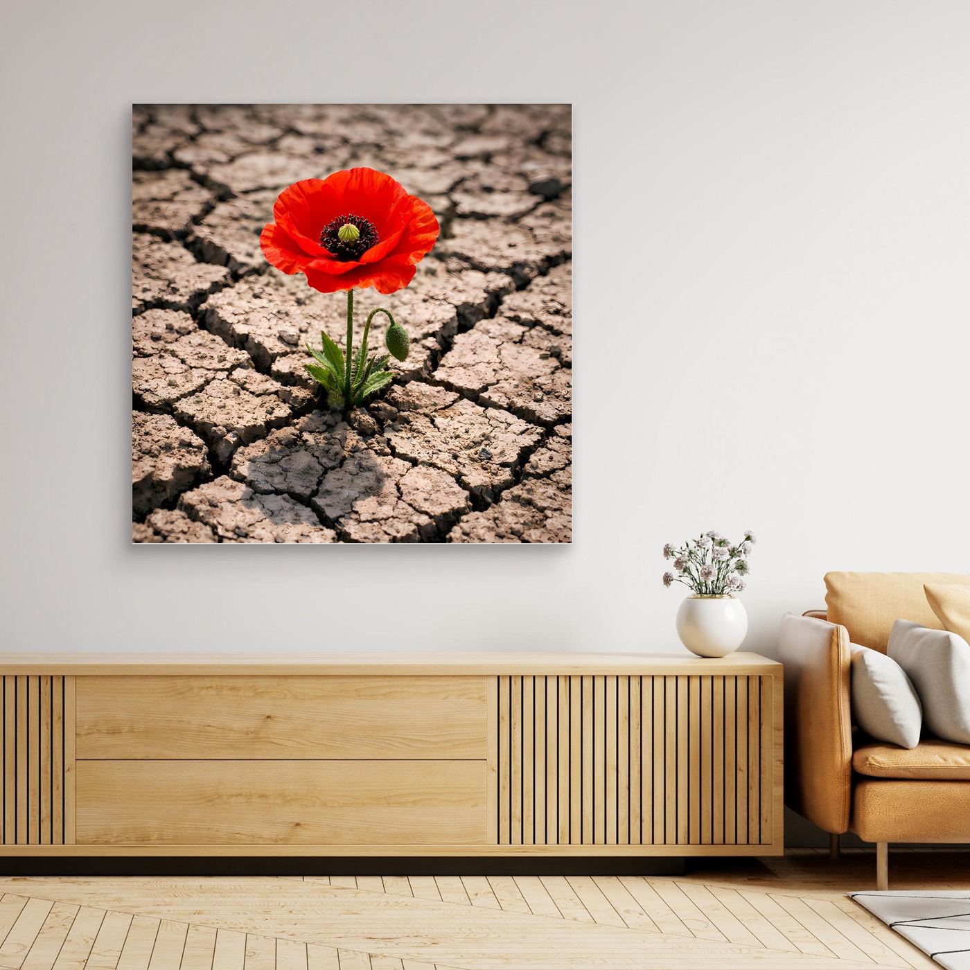 Leinwandbild mit roter Mohnblume und grünen Blättern auf rissigem Wüstenboden