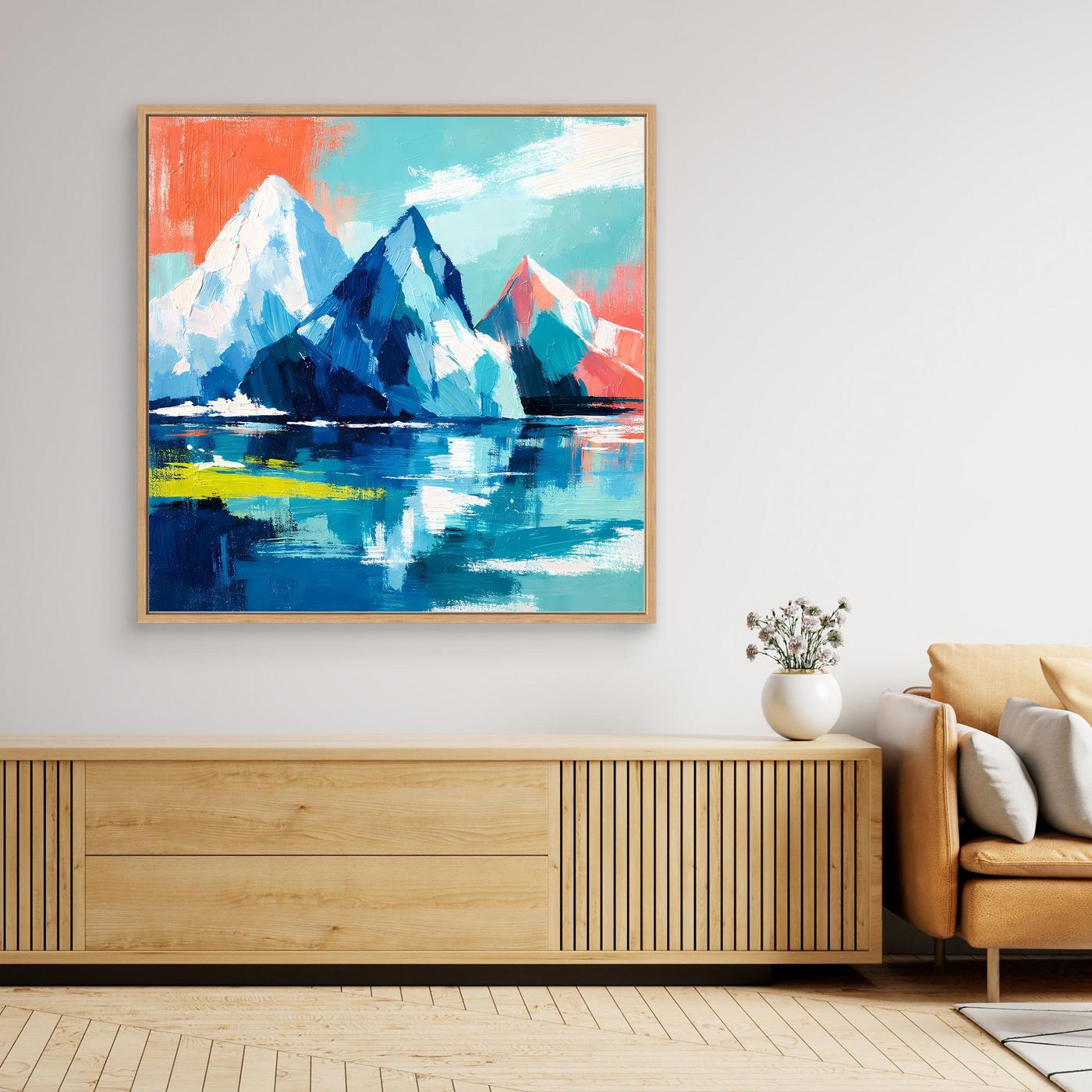 Abstract mountain and sea wall art with blue icebergs and teal sky, in a light wooden frame
