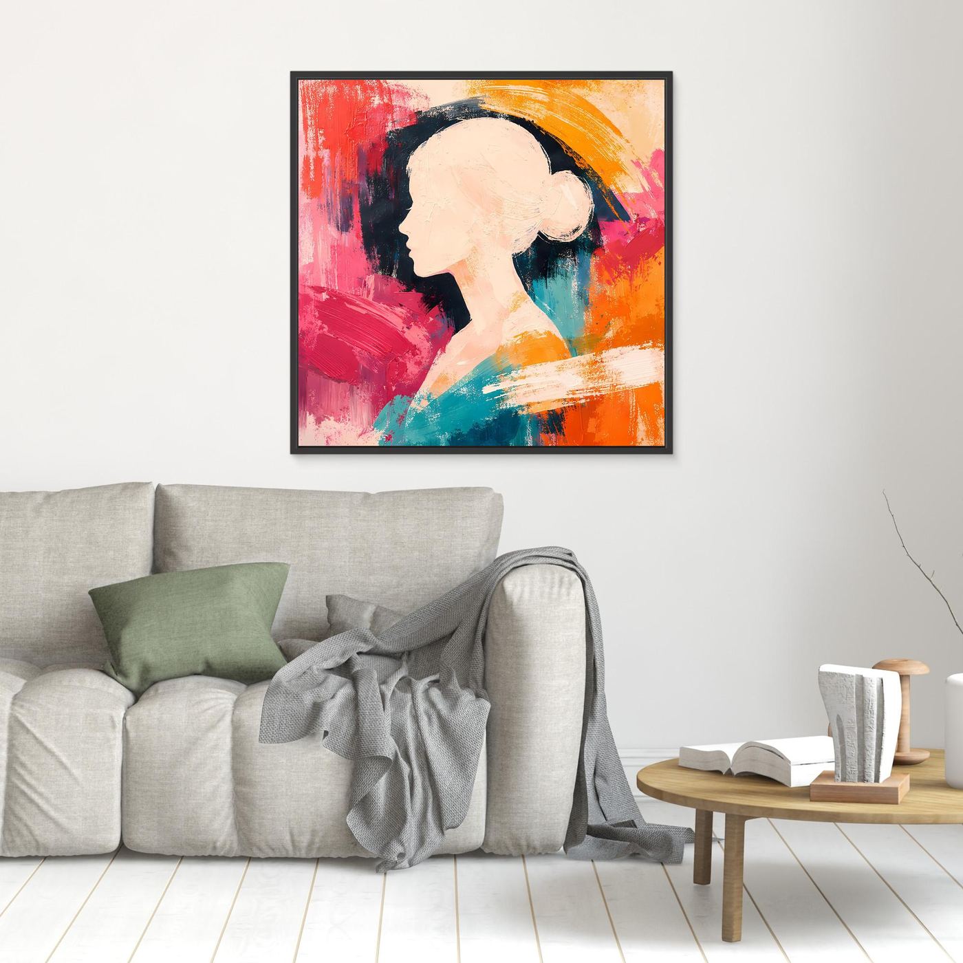 Black-framed canvas wall art with a woman profile silhouette in pink, teal, and orange abstract paint.