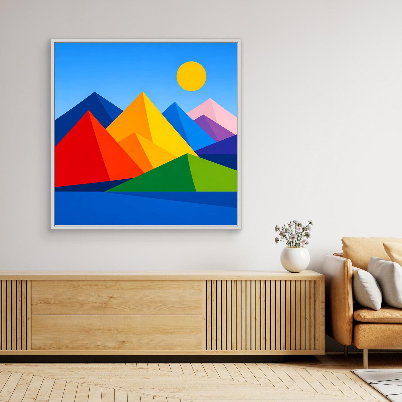 Leinwandbild mit geometrischer Berglandschaft, gelber Sonne und bunten Bergen, weißer Rahmen