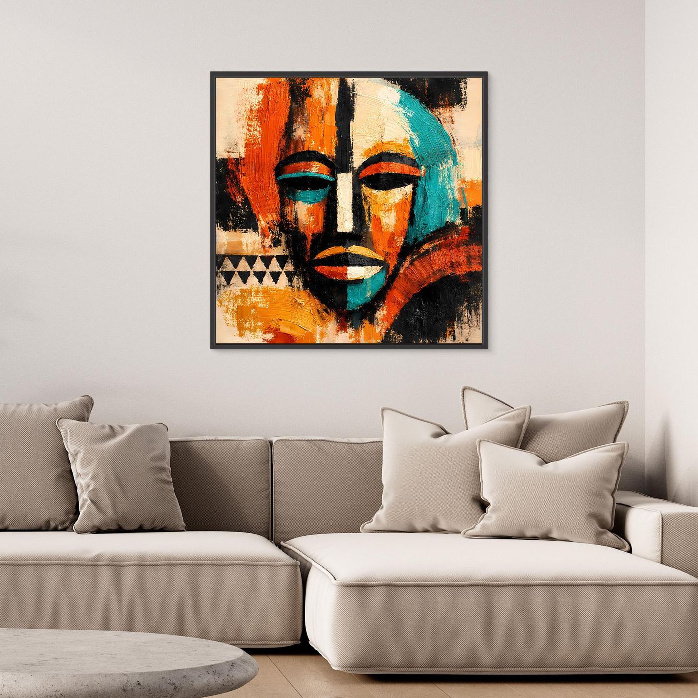 Black-framed abstract mask canvas with teal facial features, orange-red highlights, and black