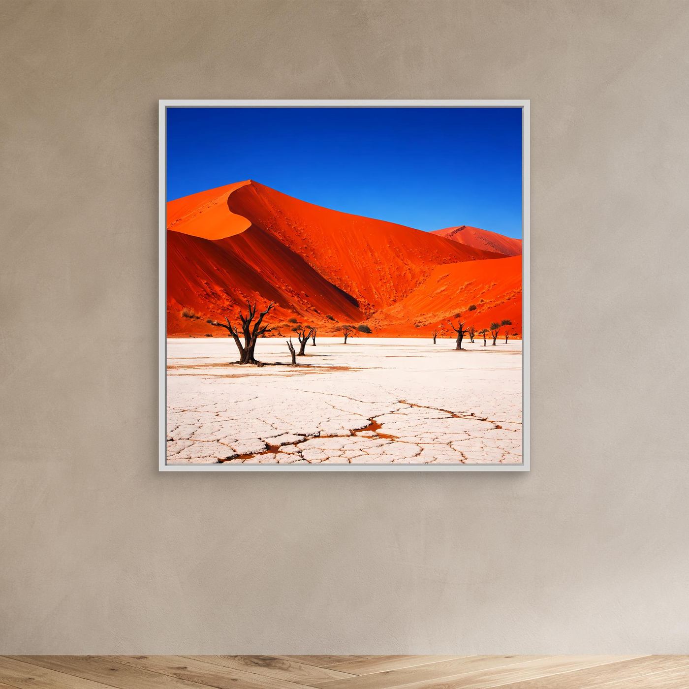 Leinwandbild: rote Dünen, blauer Himmel, karge Bäume auf rissigem Sand, weißer Rahmen