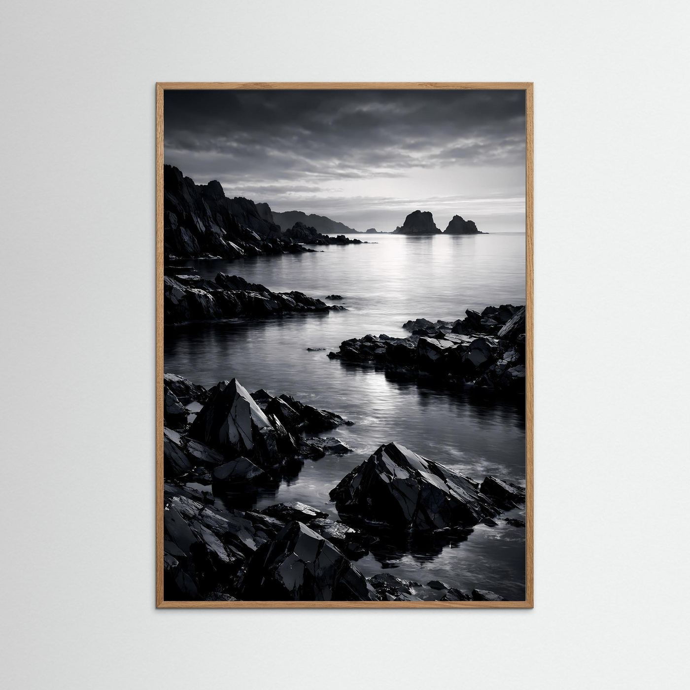 Schwarzweiß-Wandposter Felsküste: Meer und Felsen im hellbraunen Holzrahmen