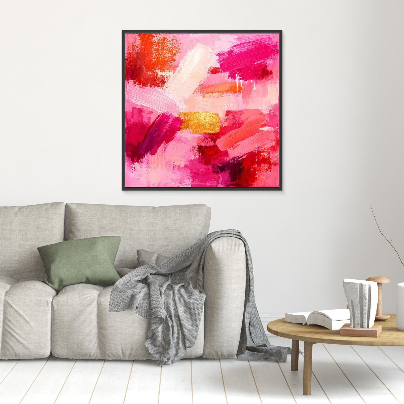 Black-framed abstract canvas wall art with pink and red brushstrokes and gold accent block