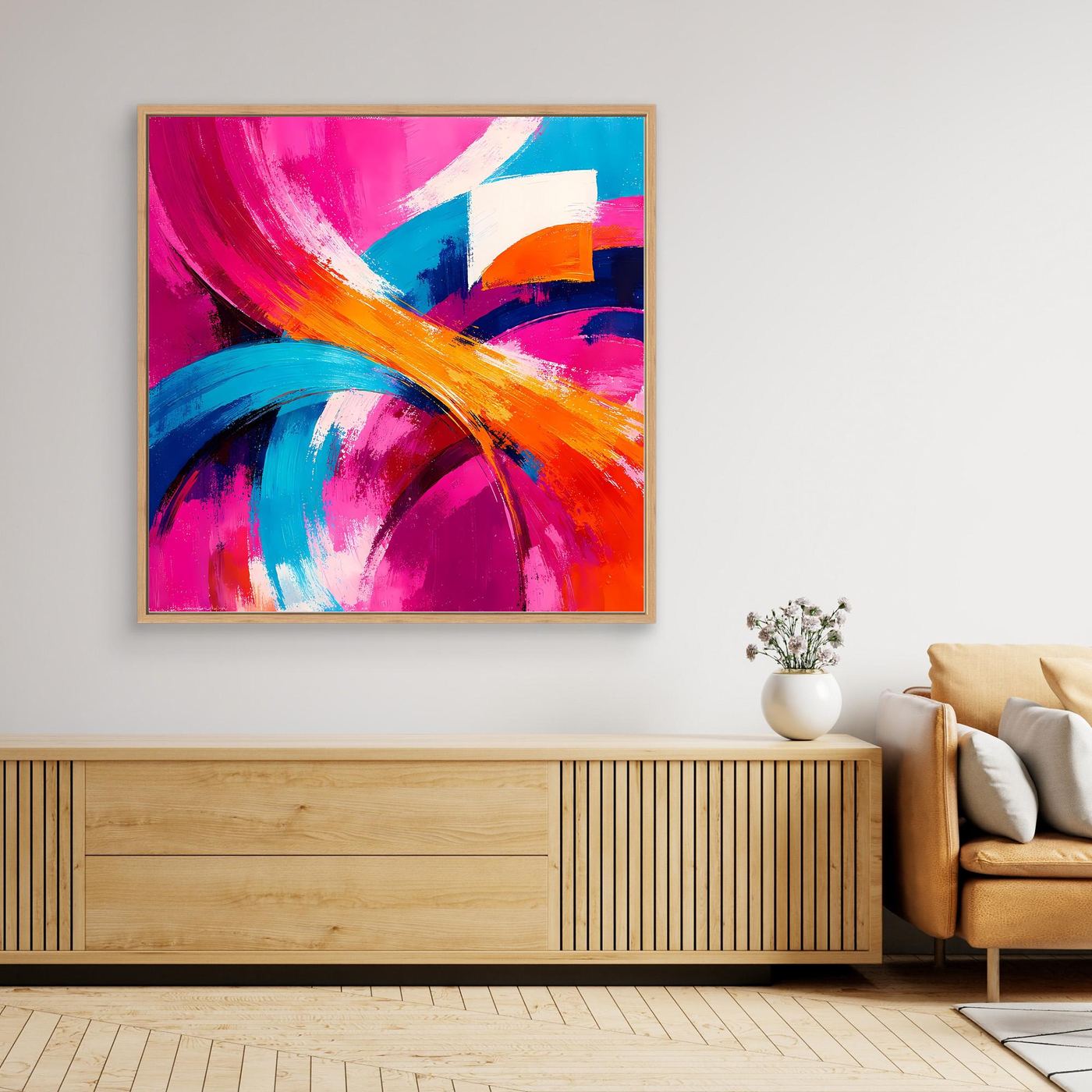 Abstraktes Leinwandbild mit Pinselstrichen in Pink, Blau und Orange, im hellen Rahmen