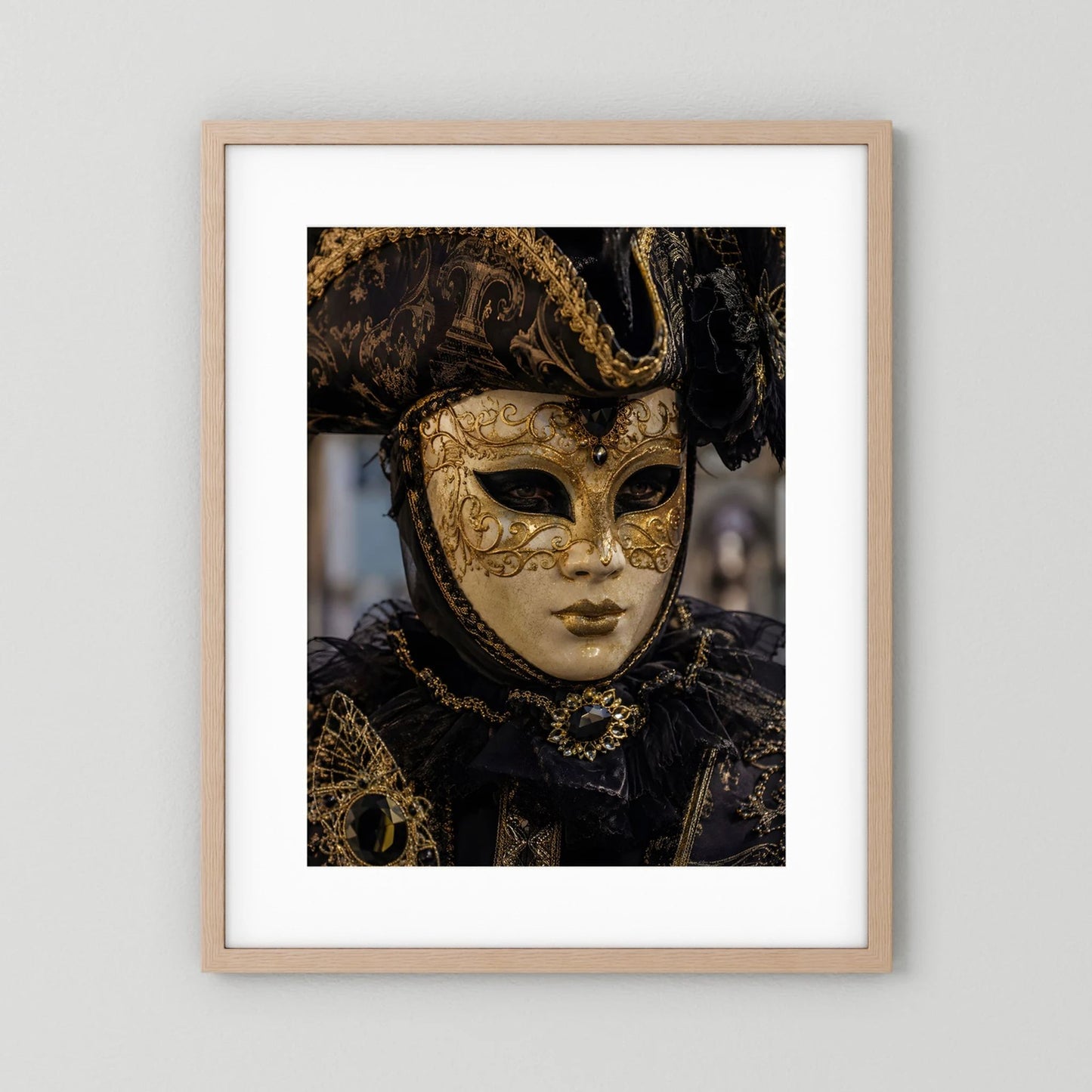 Poster im Hochformat mit venezianischer Maske in Schwarz und Gold im hellen Holzrahmen