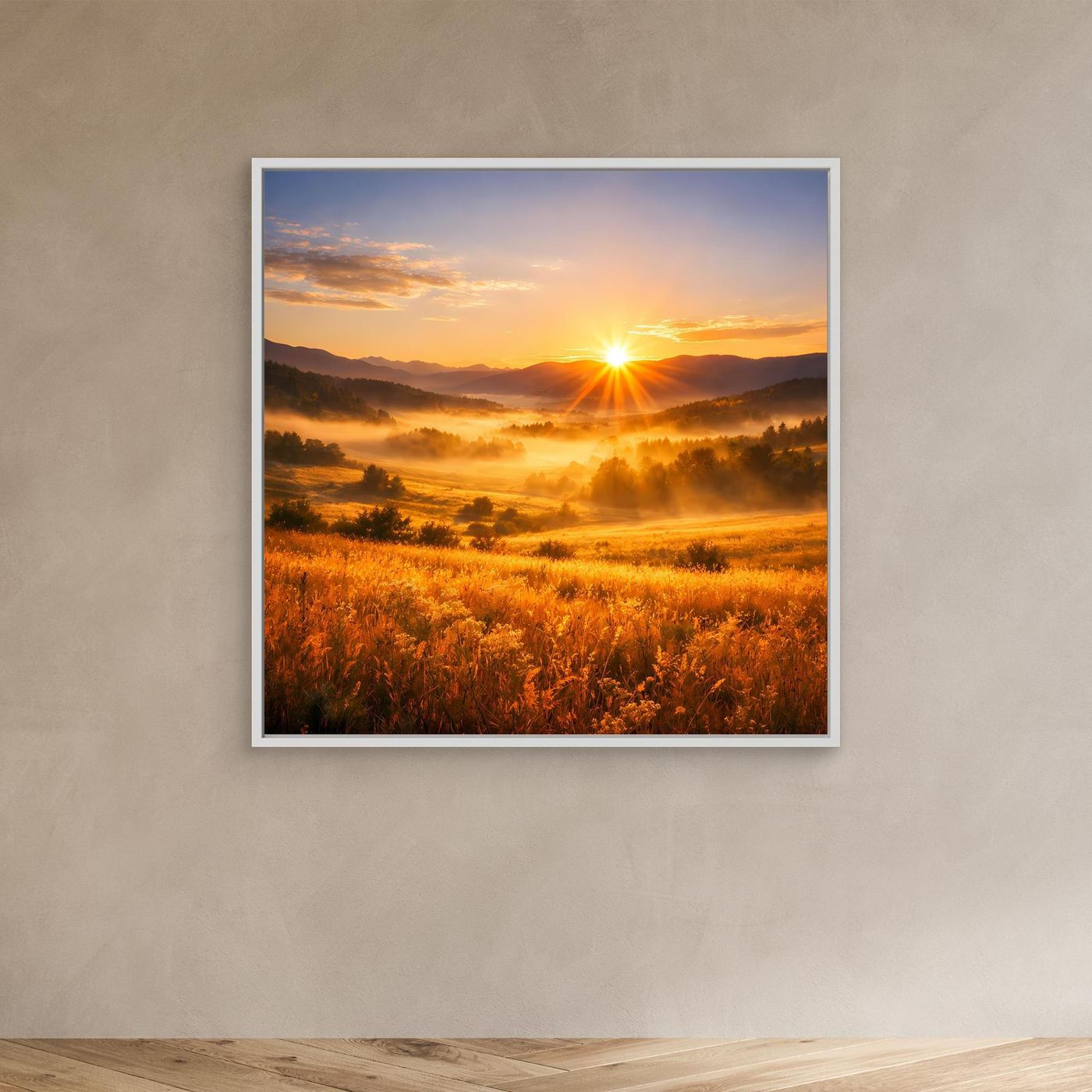 Leinwandbild im weißen Rahmen mit goldenem Sonnenaufgang über Bergtal und Feldlandschaft.